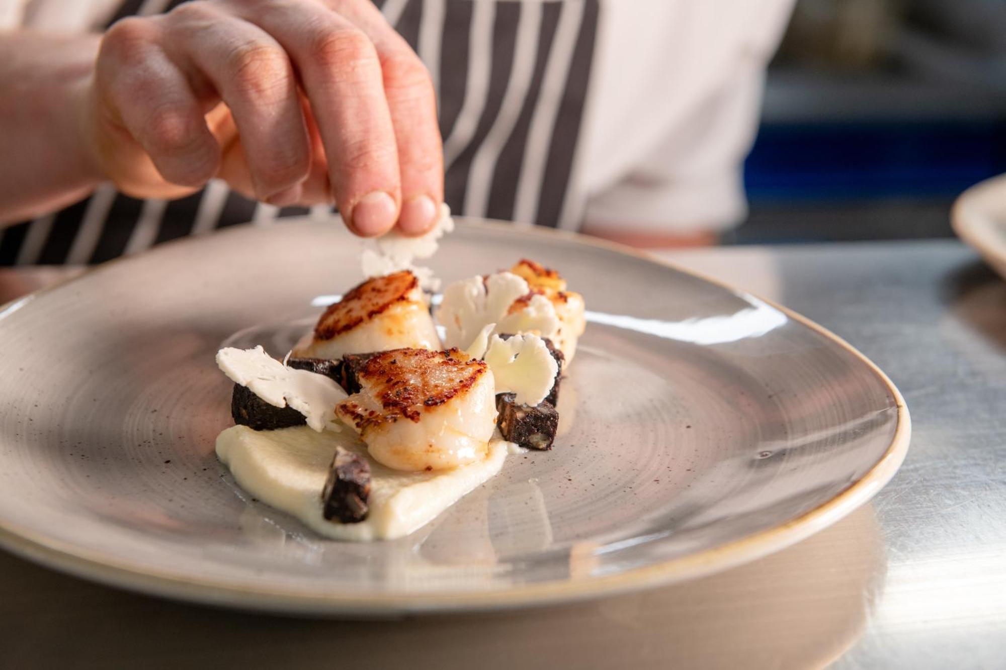 The Millstone, Mellor Otel Blackburn  Dış mekan fotoğraf A chef finishing a plate of scallops